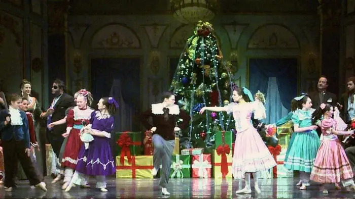 a group of actors on stage performing a scene from The Nutcracker